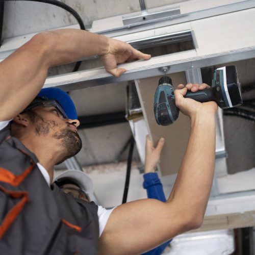 low-angle-people-working-with-drill (1)