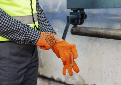 worker-putting-protective-gloves (1)