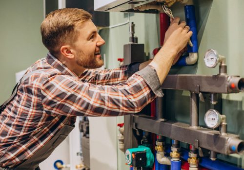 Young engineer adjusting autonomous heating